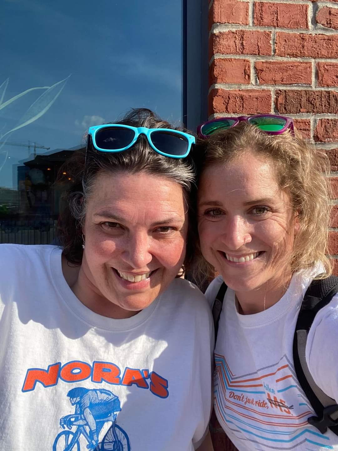 Two riders wearing Nora's team shirt